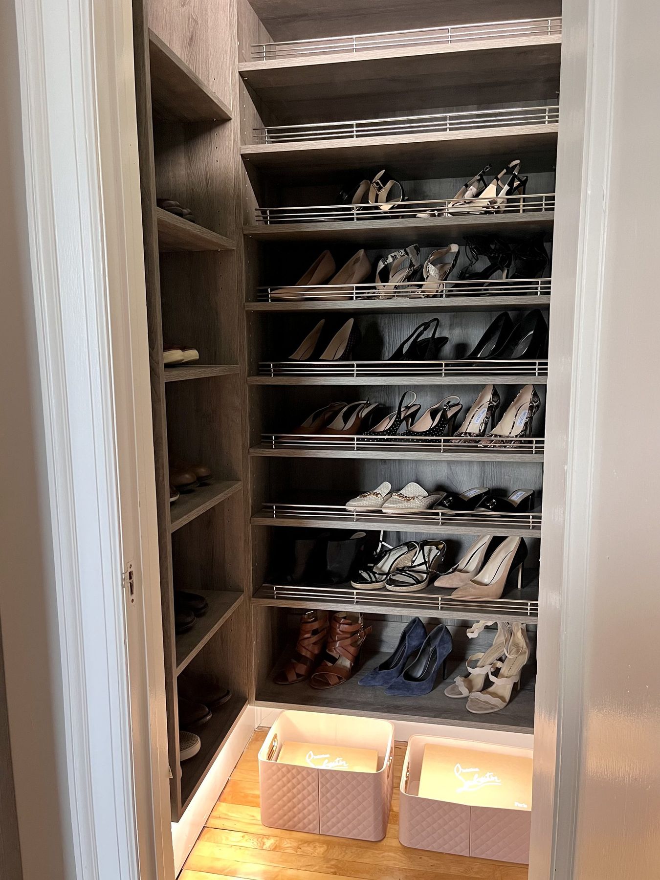 Angled shoe shelving with lighting in a reach-in closet